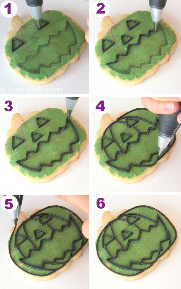 Outlining facial features with black icing.