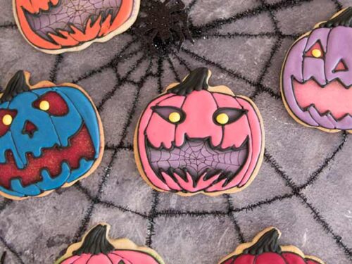 Decorated cookies displayed a spiderweb background.
