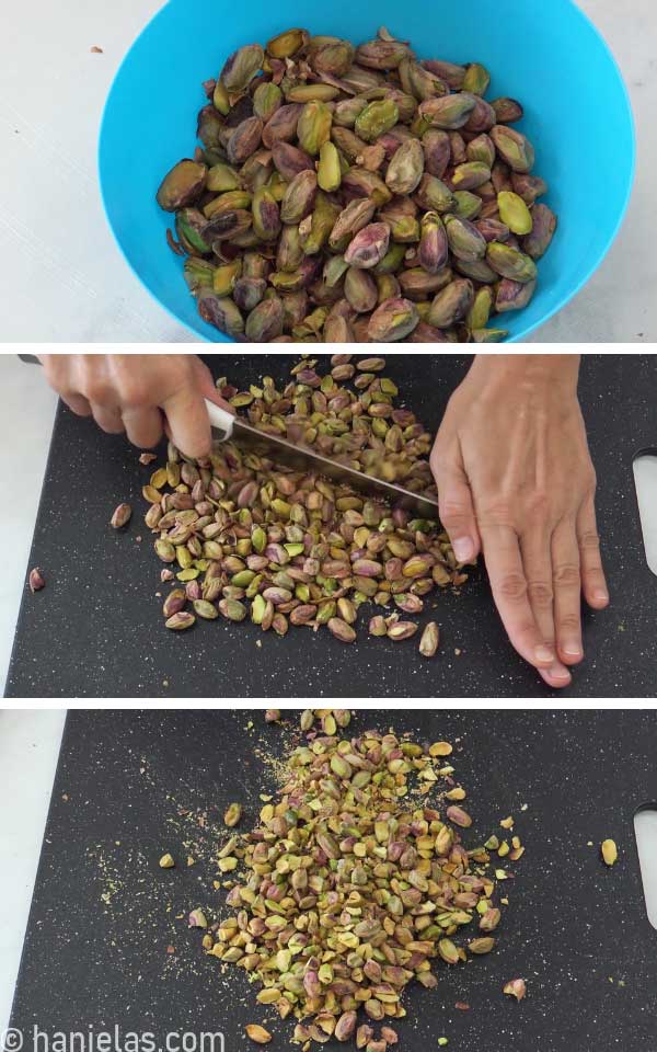 A black cutting board with cut-up pistachios.
