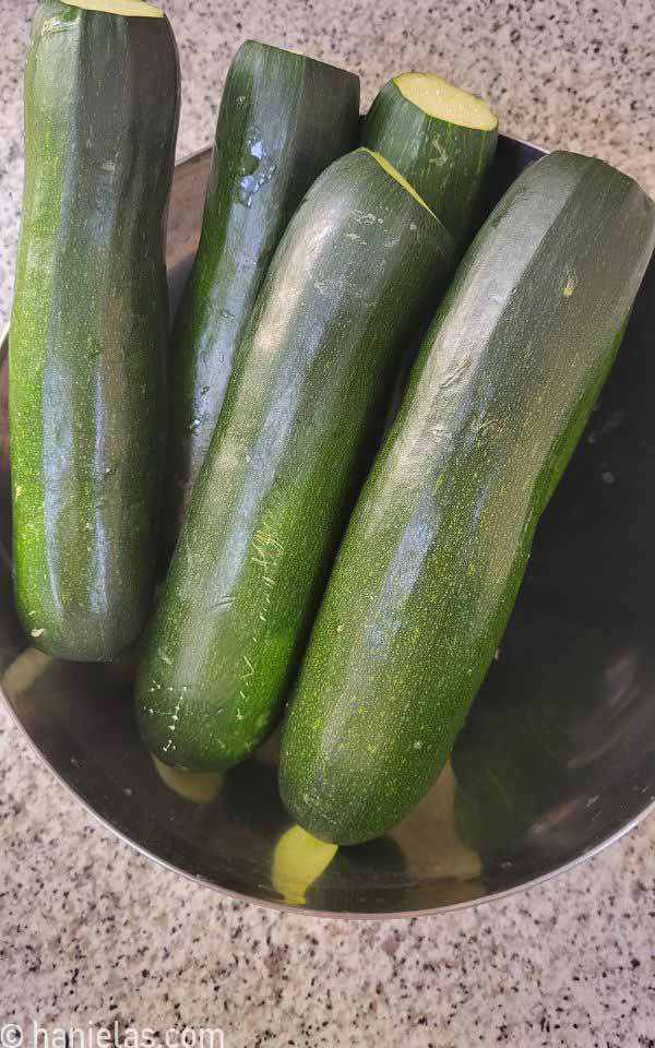 Stainless steel bowl with fresh zucchini.