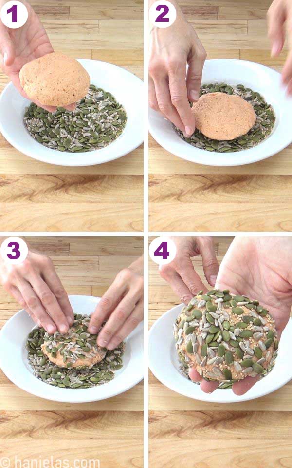 A white plate with seeds, a hand holding a bagel dipped in seeds.