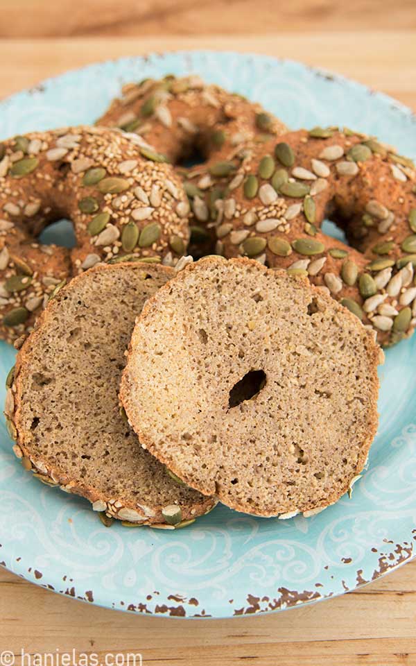 A place with baked bagels, one of them sliced open, showing texture inside.
