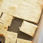 View from above, baked sheet bread on a cutting board.