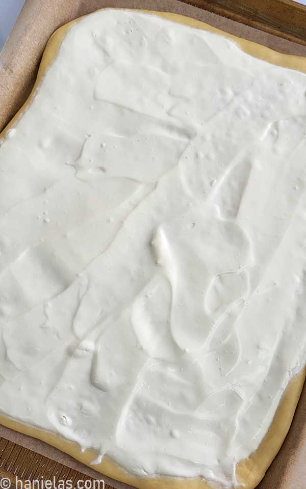 White creamy topping spread on a bread.