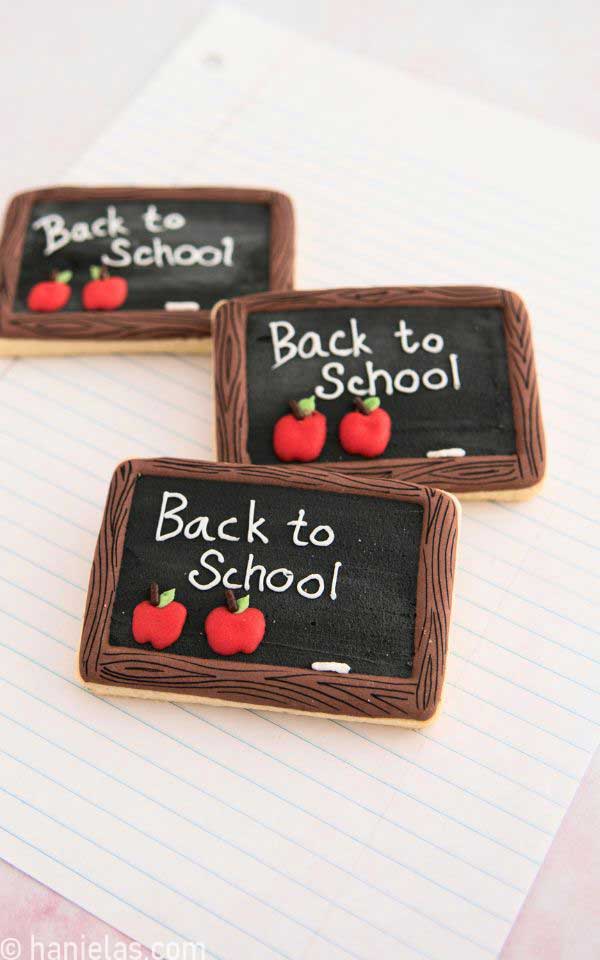 Decorated rectangular cookies like chalkboard displayed on a lined paper.