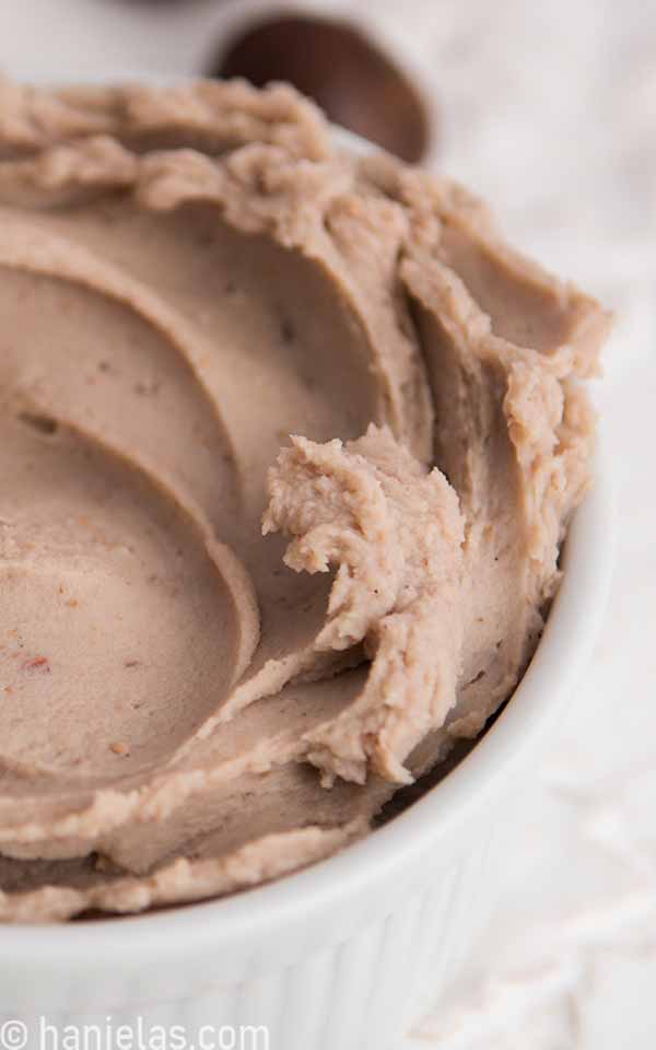 A close-up of thick puree in a white ramekin.