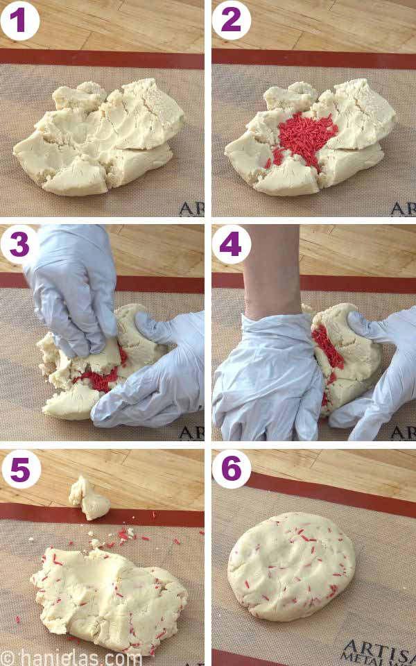 Hand kneading red sprinkles into a cookie dough.