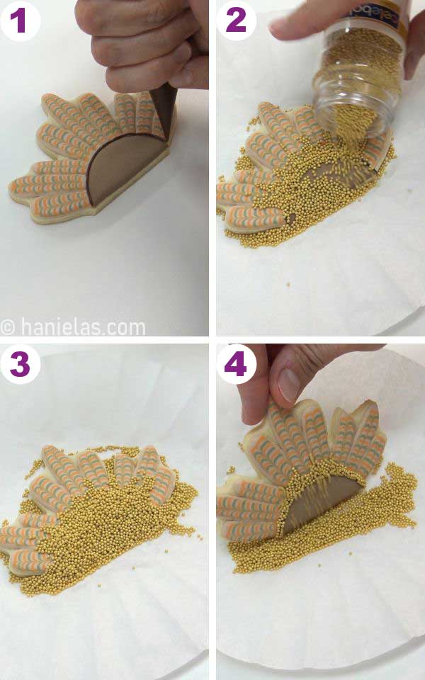 Adding gold sprinkles onto a piped line of royal icing.