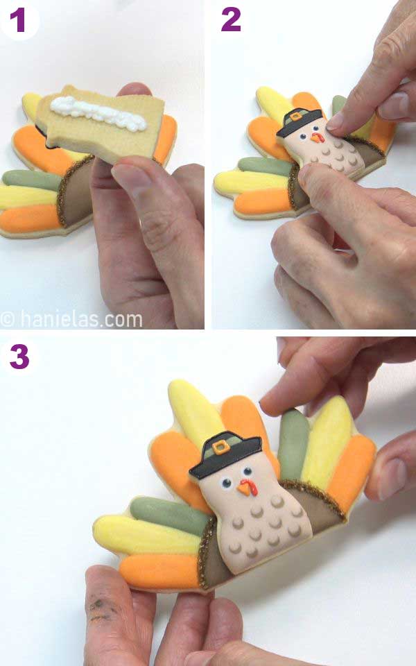 Gluing a turkey head cookie on a maple leaf feather cookie.
