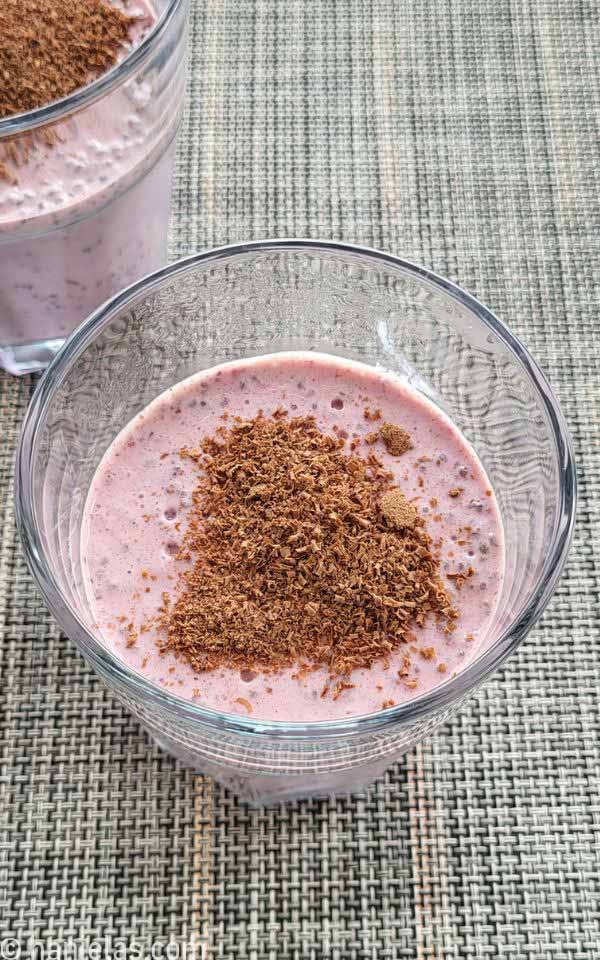 Glass filled with set pudding and chocolate shavings on the top.