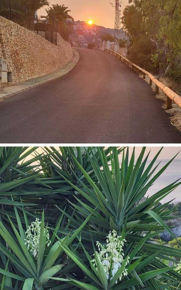 An image of a road with a view of a sunrise.