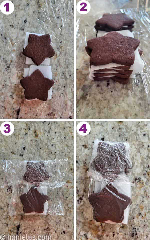 A stack of star shaped cookies layered between parchment paper.