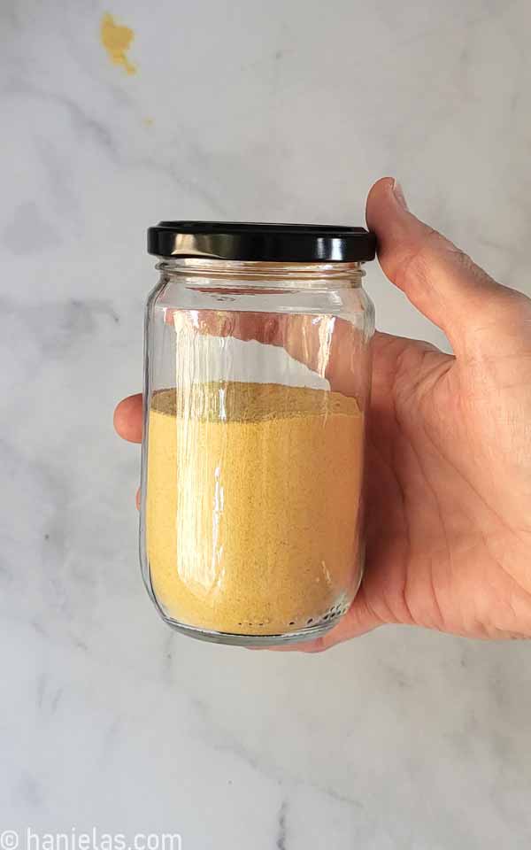 A glass jar with toasted milk powder.